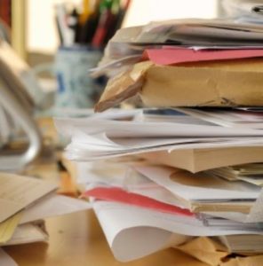 messy pile of paper mail on desk