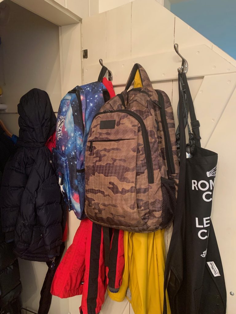 Image of backpacks hung up in closet